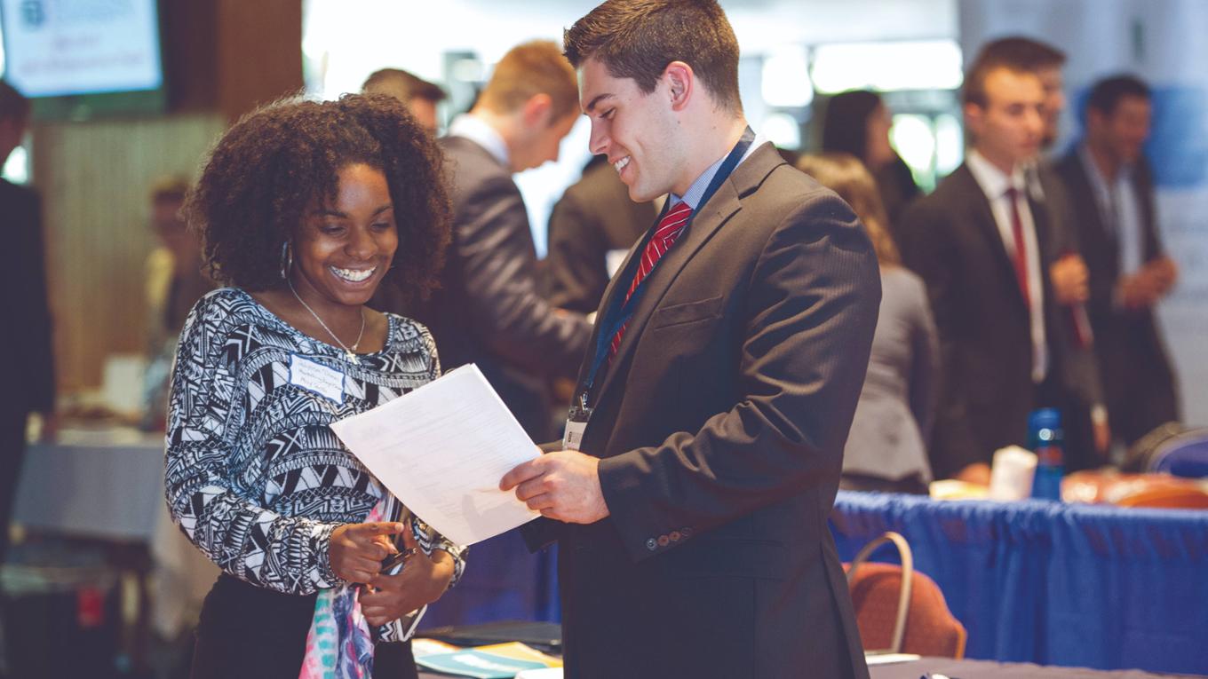 Female and male student talking at a Career Fair