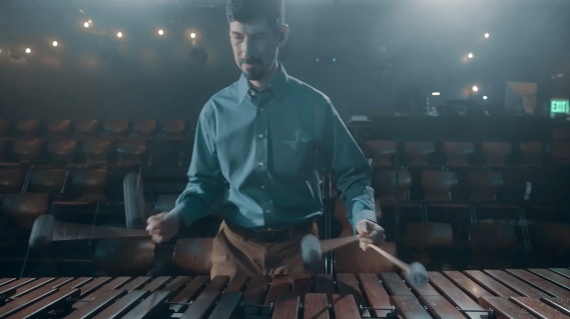 percussionist plays marimba using four mallets