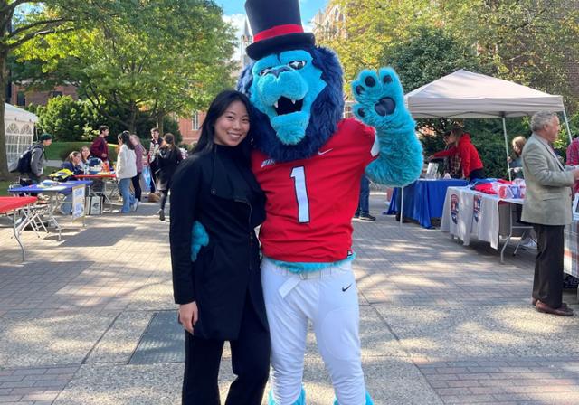 student with mascot at event