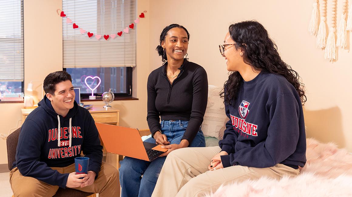 Duquesne students chatting in dorm room