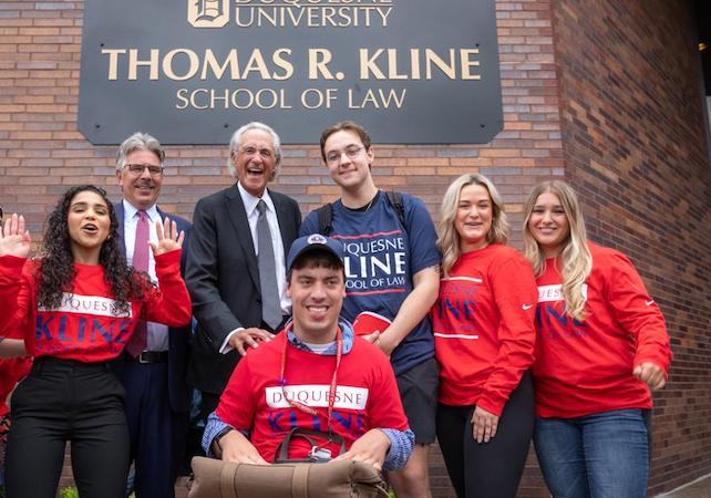 Duquesne students smiling with Thomas R. Kline